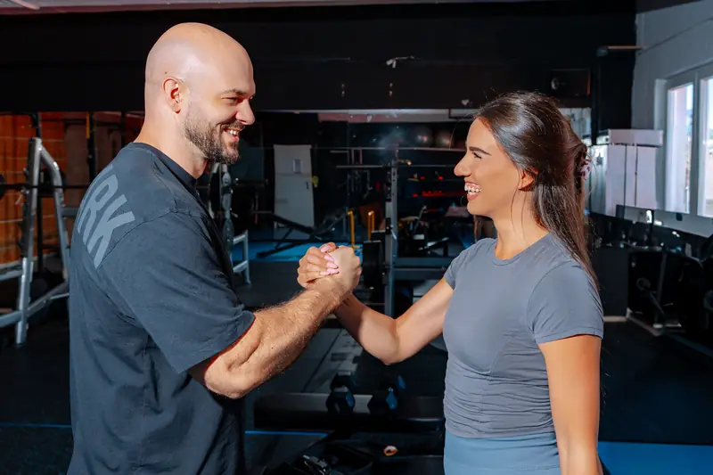 Two lifters shaking hands at the gym