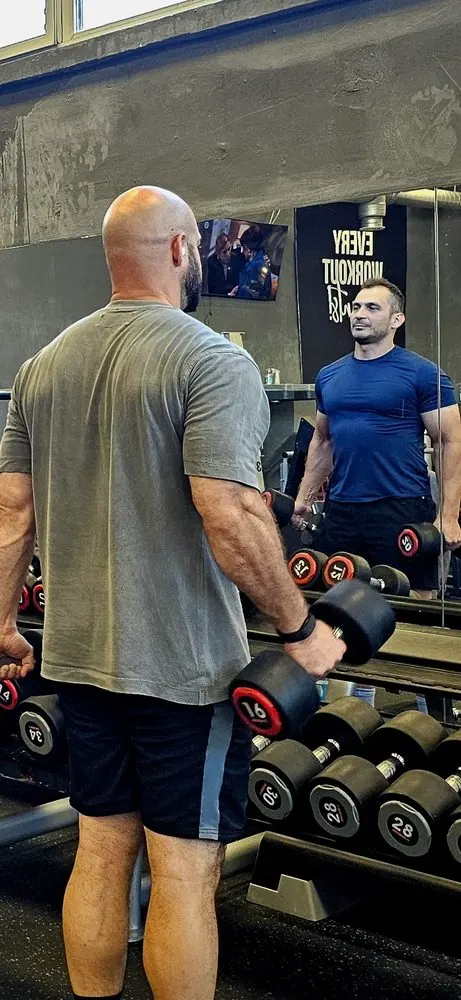 A lifter re-racking dumbbells